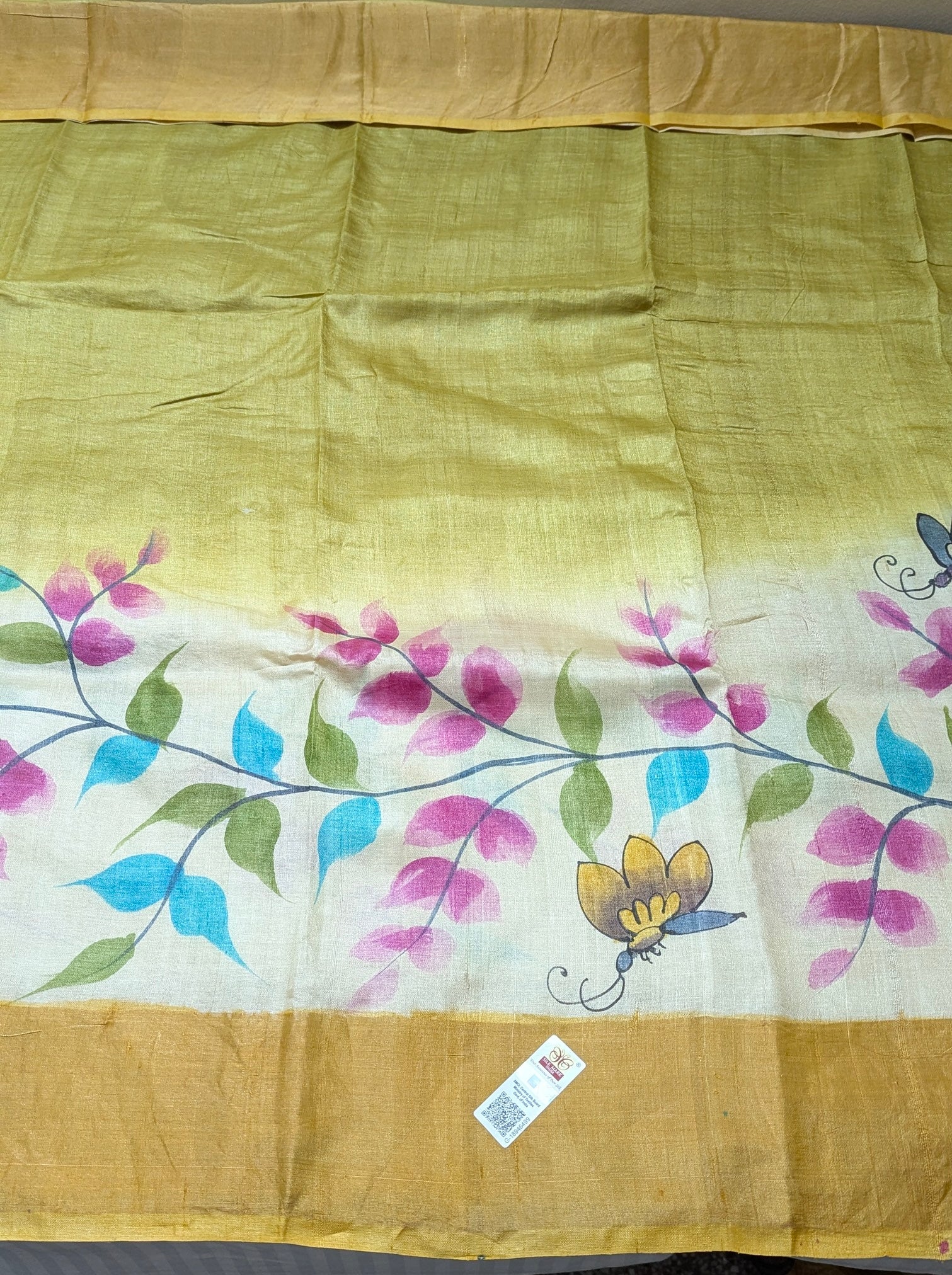Saree with floral design and butterfly on a yellow background