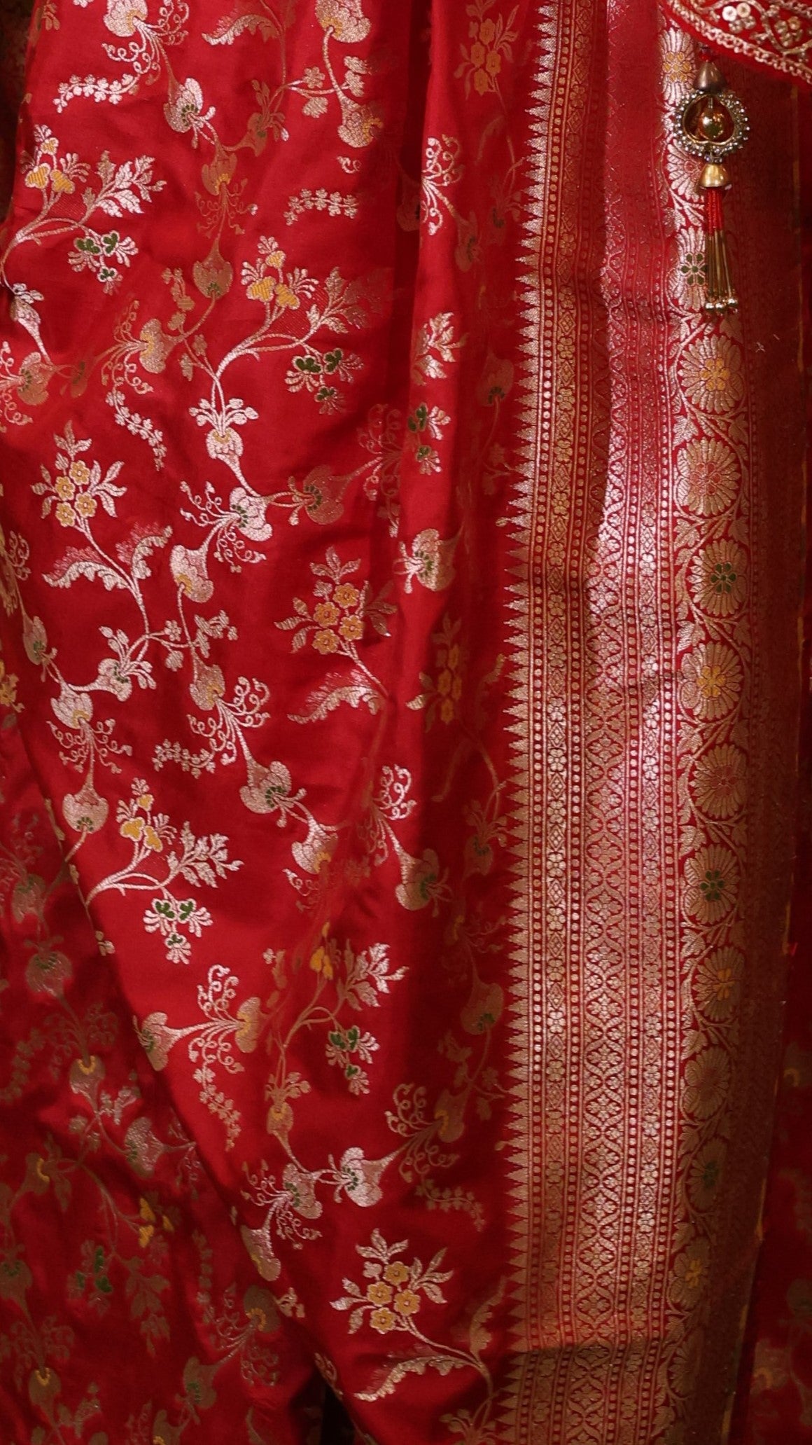 Close up of Red Pure Katan Silk saree with floral meenakari work.