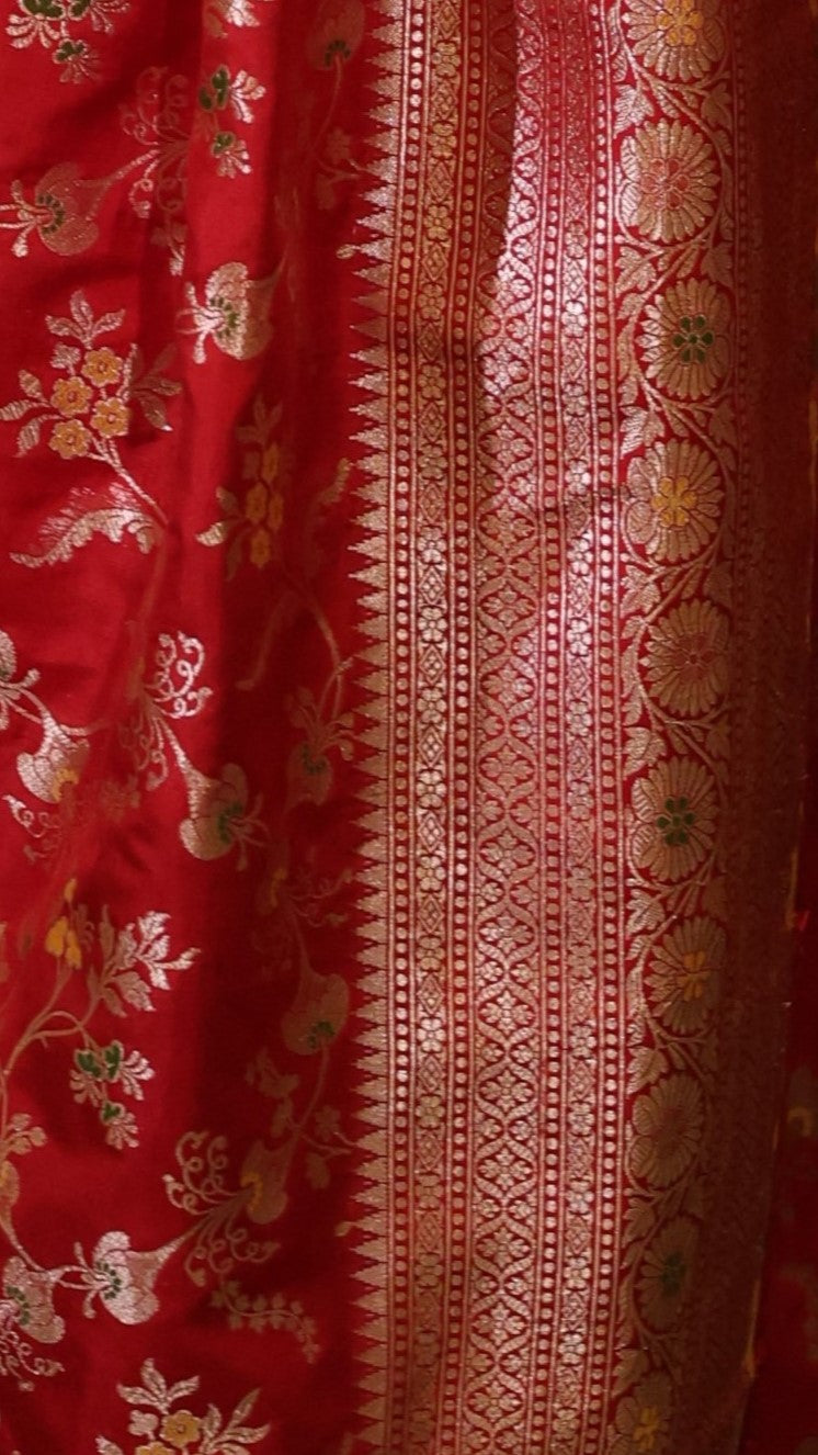 Close up of Red Pure Katan Silk saree with floral meenakari work.