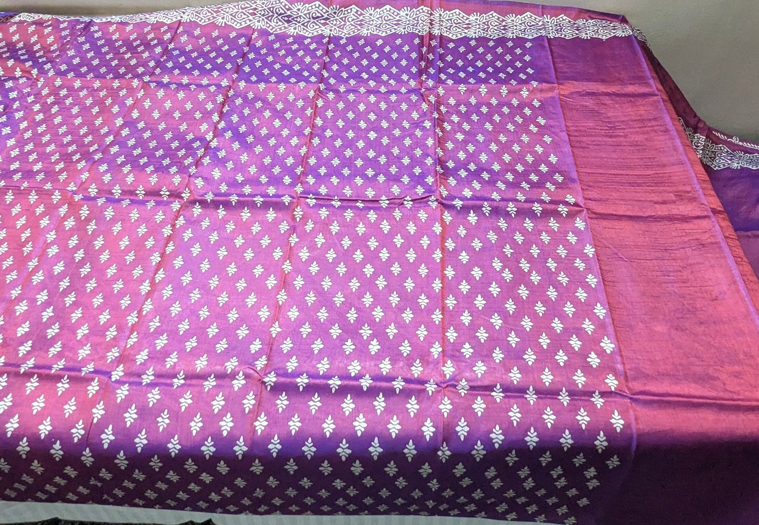 Body of Purple Katan Silk, with clear images of white motifs, with running blouse piece.
